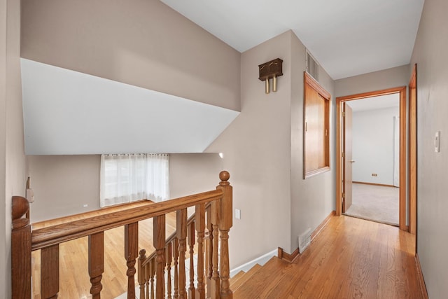 hallway with light hardwood / wood-style flooring