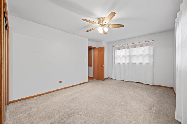 carpeted empty room featuring ceiling fan