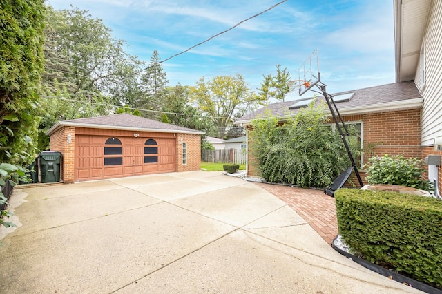 view of home's exterior featuring a garage and an outbuilding