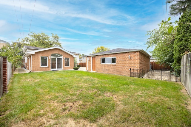 rear view of house with a lawn