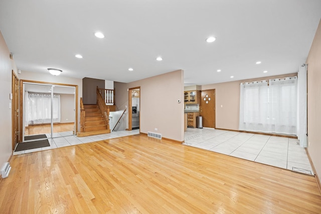 unfurnished living room with light wood-type flooring