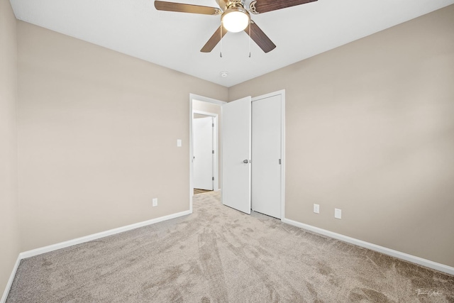 unfurnished bedroom with ceiling fan and light carpet