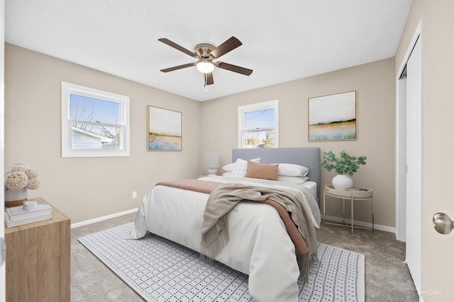 carpeted bedroom with a closet and ceiling fan