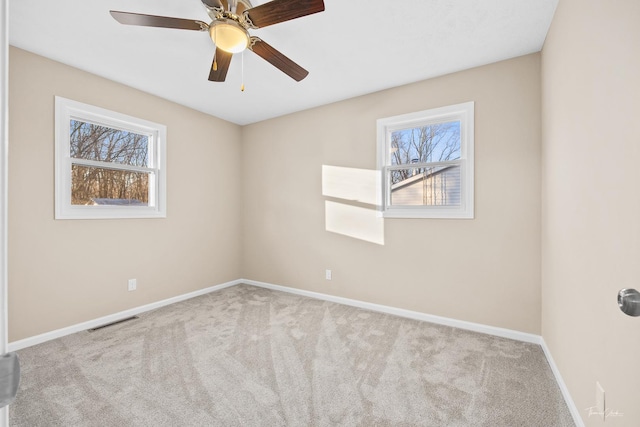 carpeted empty room featuring ceiling fan