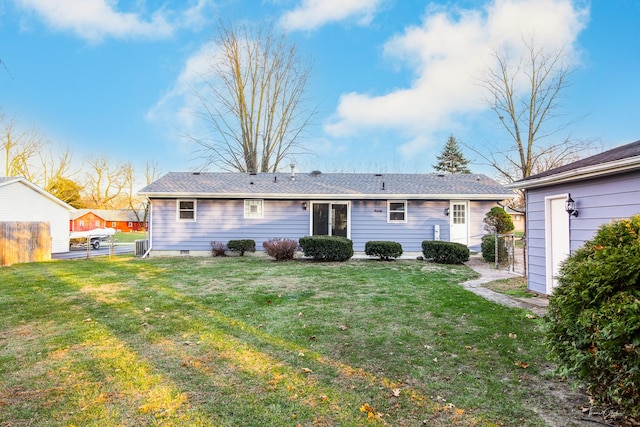 rear view of house featuring a yard