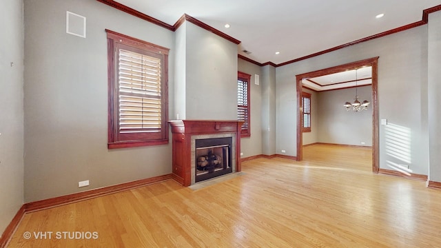 living room featuring ornamental molding, light hardwood / wood-style floors, and a notable chandelier