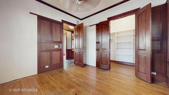 unfurnished bedroom with light hardwood / wood-style floors, ceiling fan, and crown molding