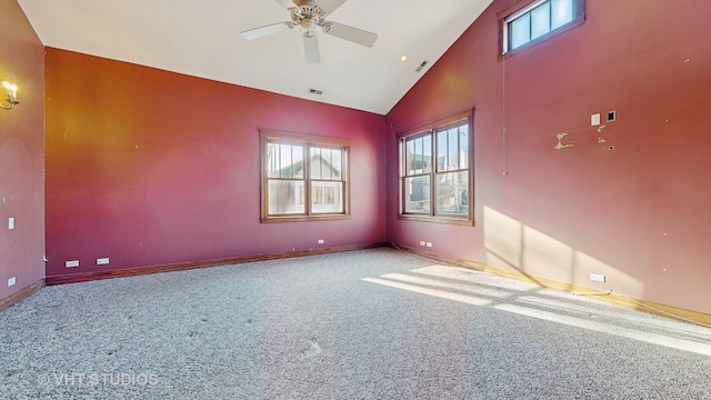 unfurnished room with high vaulted ceiling, ceiling fan, and carpet