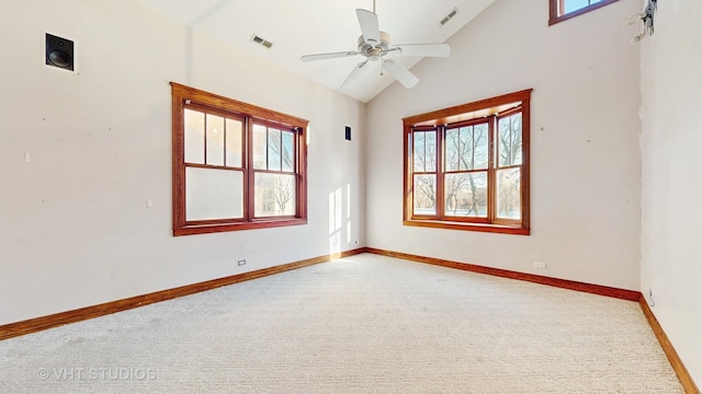 carpeted empty room featuring ceiling fan and vaulted ceiling