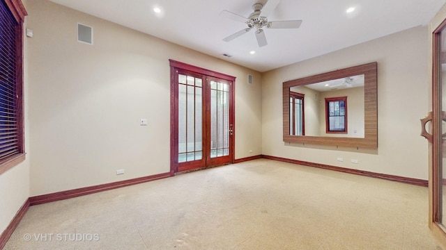 carpeted spare room with ceiling fan