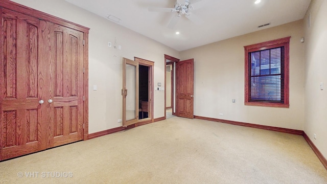 unfurnished bedroom featuring ceiling fan and light carpet