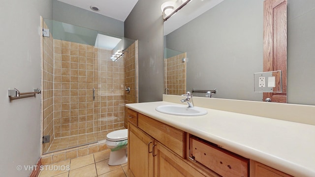 bathroom featuring vanity, tile patterned flooring, toilet, and a shower with shower door