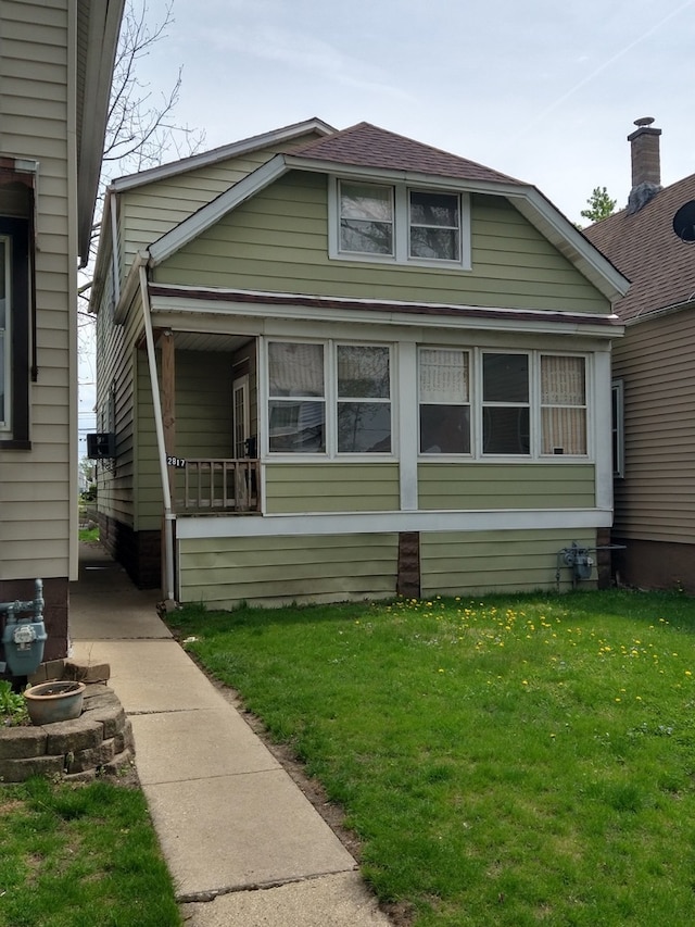 view of side of home with a lawn