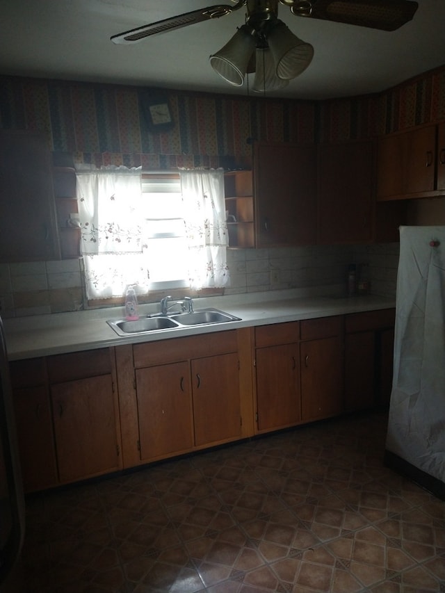 kitchen featuring ceiling fan and sink