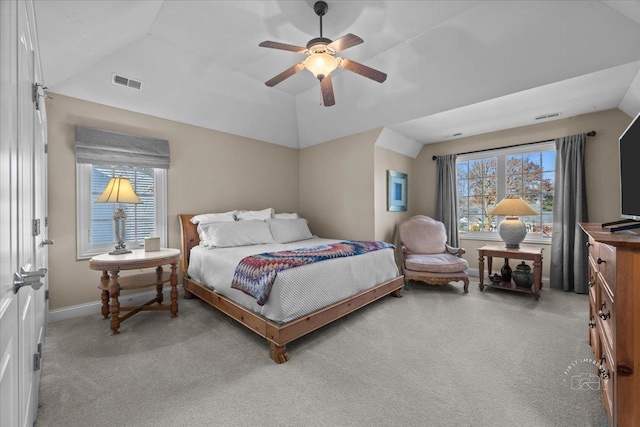 bedroom with light carpet, multiple windows, vaulted ceiling, and ceiling fan