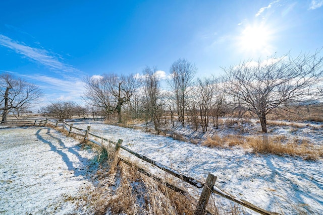 yard layered in snow featuring a rural view