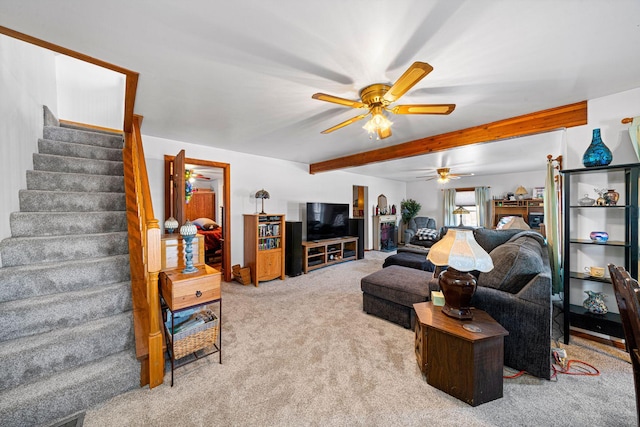 living room featuring beamed ceiling, ceiling fan, and light colored carpet