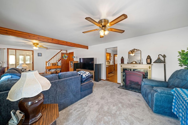 carpeted living room with beamed ceiling and ceiling fan