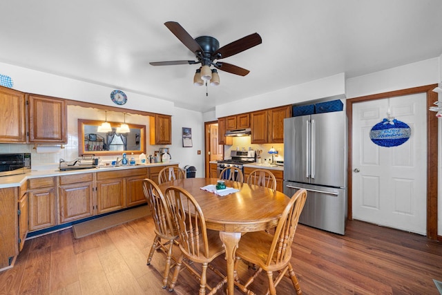 dining room featuring ceiling fan, wood-type flooring, and sink