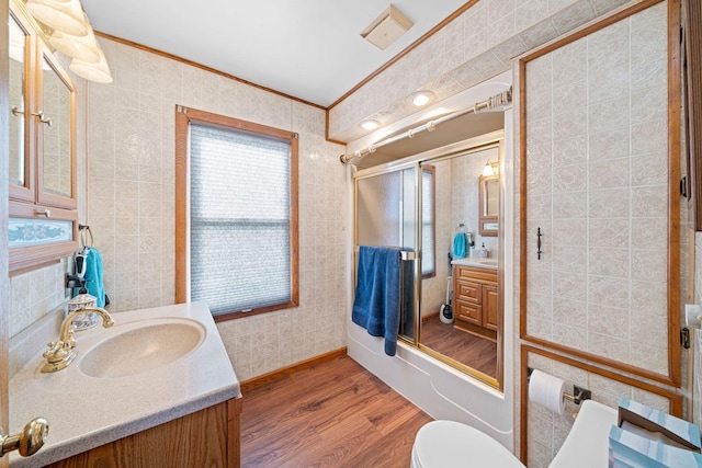 full bathroom featuring crown molding, toilet, shower / bath combination with glass door, vanity, and hardwood / wood-style flooring