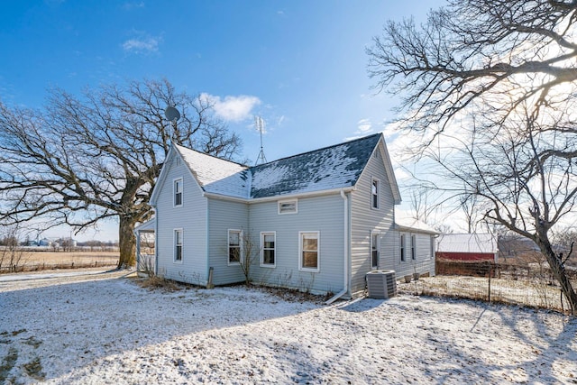 snow covered property featuring central AC