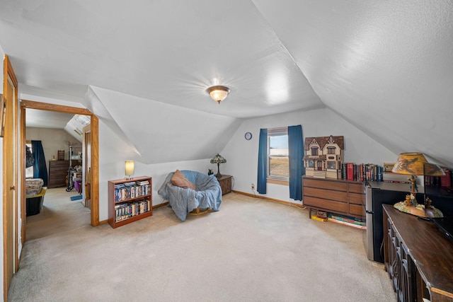 bedroom with light colored carpet and vaulted ceiling