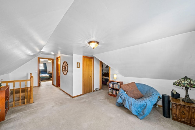 bonus room with light colored carpet and lofted ceiling