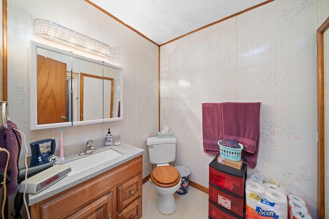 bathroom featuring vanity, tile patterned flooring, decorative backsplash, toilet, and ornamental molding