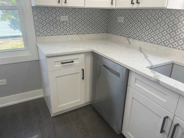 kitchen featuring light stone countertops, tasteful backsplash, and stainless steel dishwasher