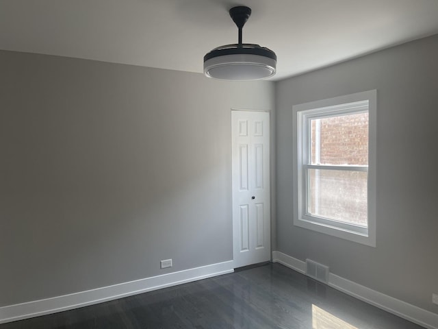 spare room featuring dark hardwood / wood-style floors