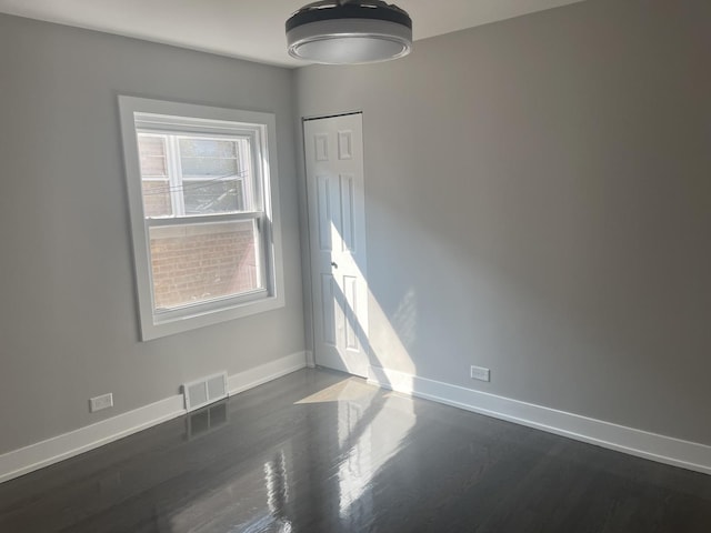 empty room featuring dark wood-type flooring