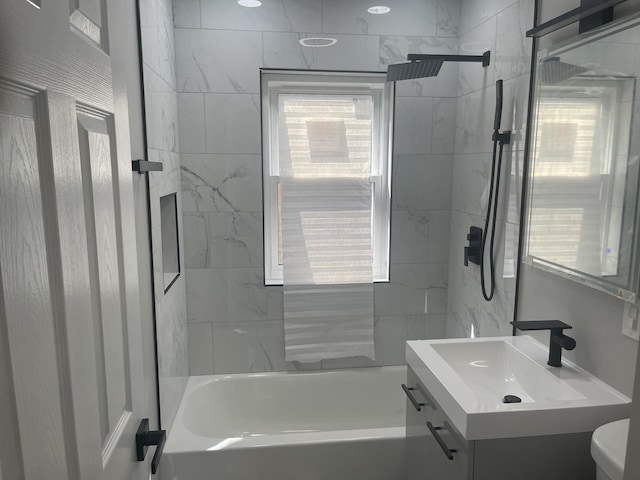 full bathroom featuring vanity, toilet, and tiled shower / bath combo