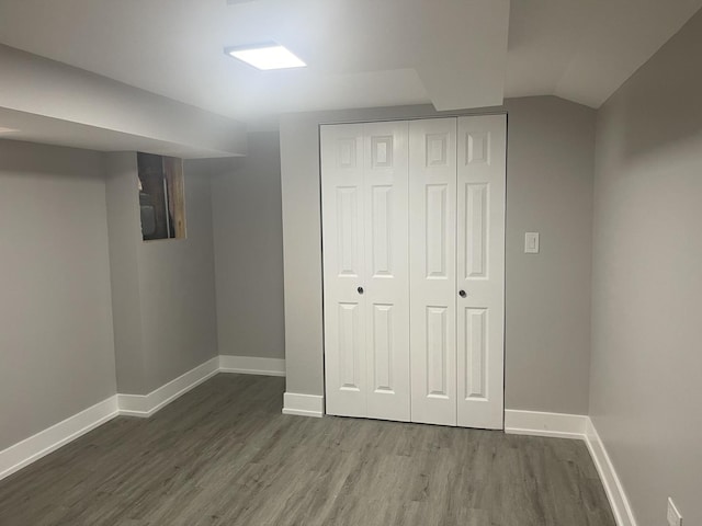 basement with dark hardwood / wood-style flooring