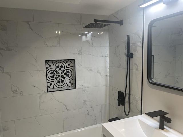 bathroom with sink and tiled shower / bath