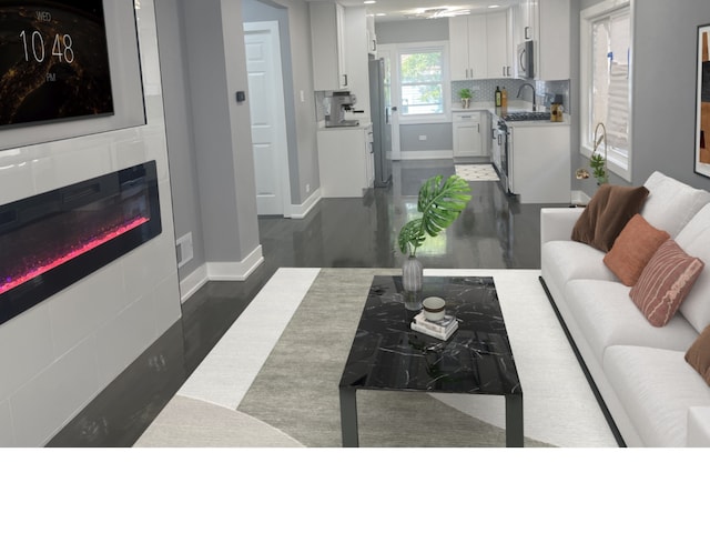 living room featuring dark hardwood / wood-style flooring and a tiled fireplace