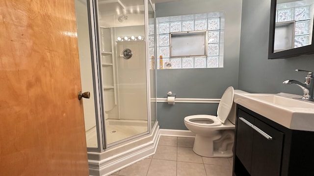 bathroom with tile patterned floors, vanity, toilet, and a shower with shower door