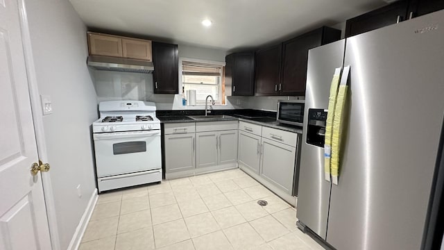 kitchen featuring light tile patterned flooring, appliances with stainless steel finishes, and sink