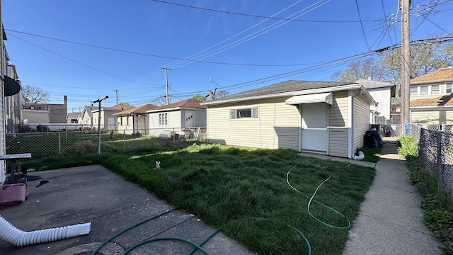 rear view of property featuring a yard