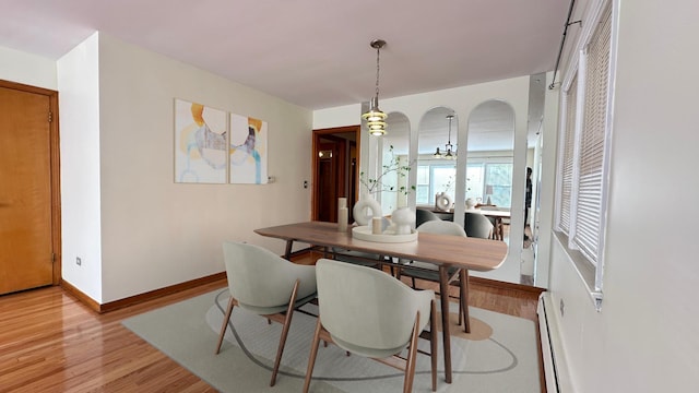 dining room with light wood-type flooring and a baseboard radiator