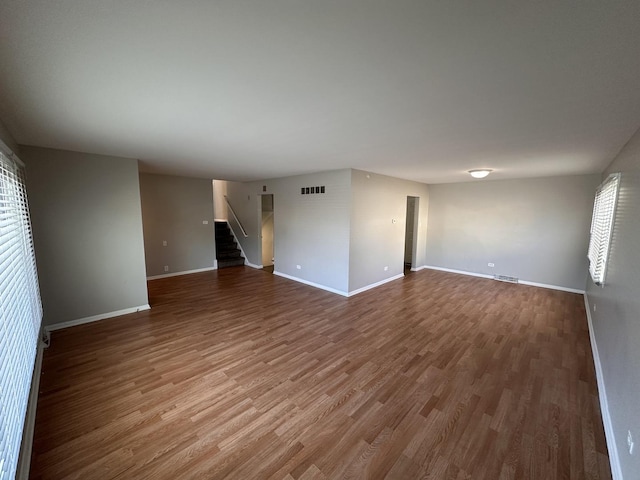 unfurnished room with wood-type flooring