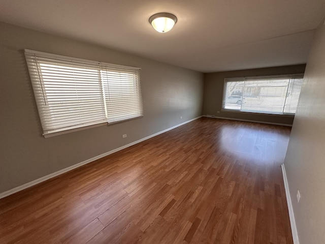 spare room featuring dark hardwood / wood-style flooring