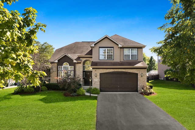 view of front of property with a front yard and a garage