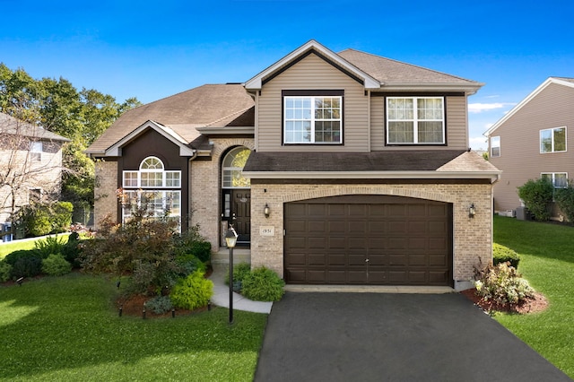 view of front of house with a garage and a front lawn