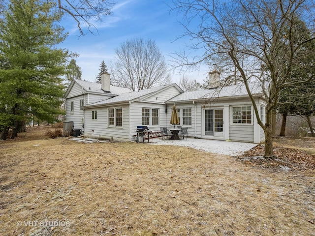 rear view of house featuring cooling unit and a patio