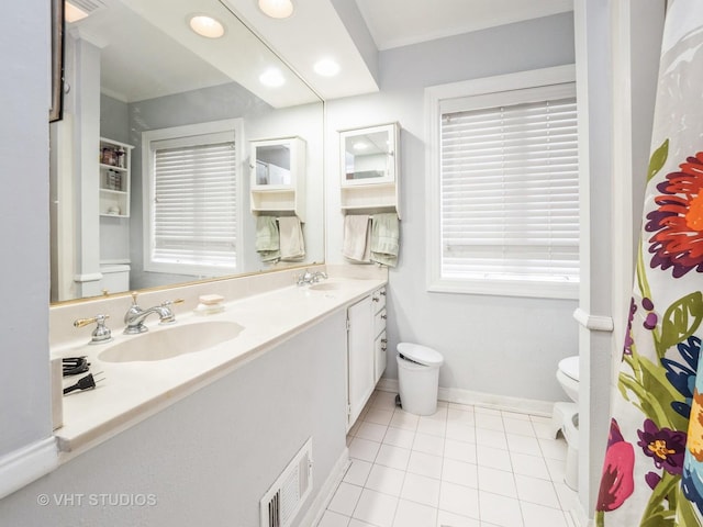 bathroom with tile patterned floors, vanity, toilet, and ornamental molding