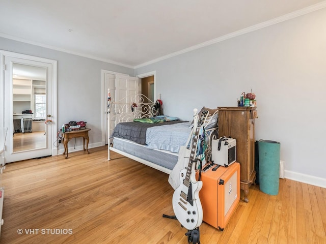 bedroom featuring hardwood / wood-style flooring and ornamental molding