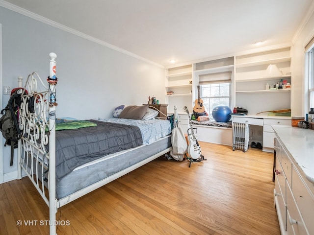 bedroom with light hardwood / wood-style flooring and crown molding