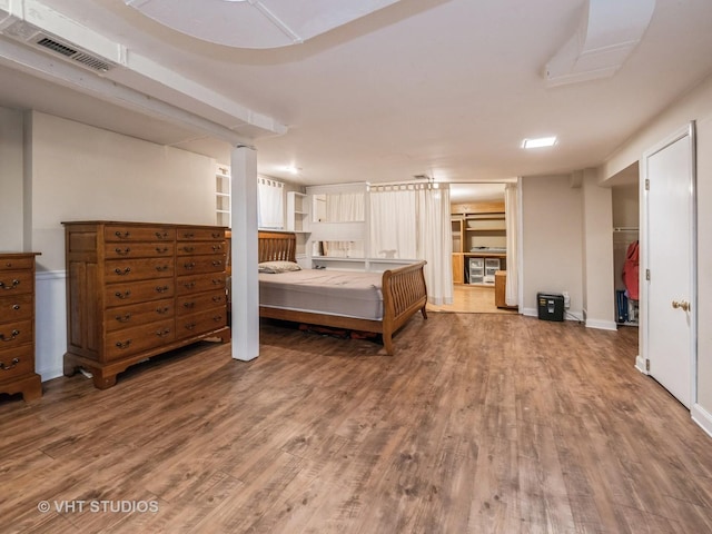 bedroom with a closet and hardwood / wood-style flooring