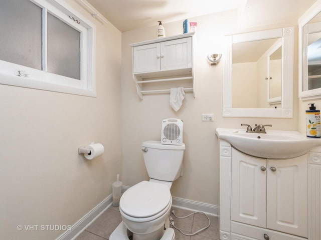 bathroom with tile patterned floors, vanity, and toilet