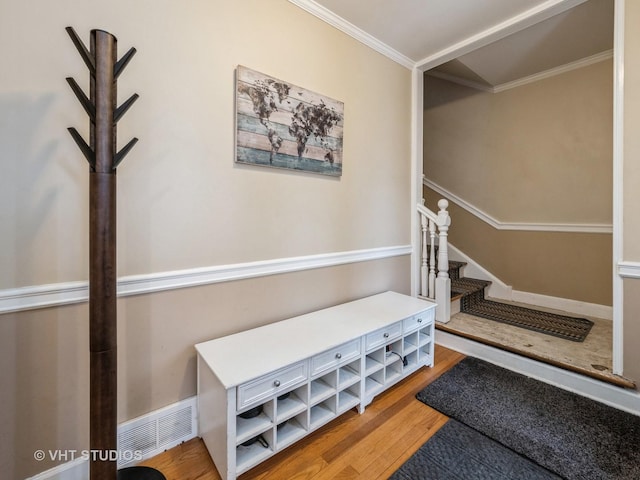 interior space with wood-type flooring and ornamental molding